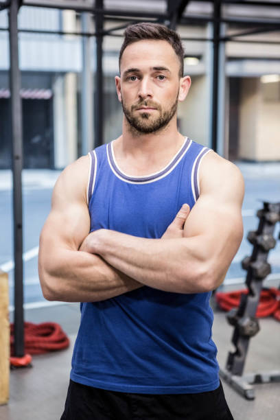 istock Muscular man standing with arms crossed 841086990