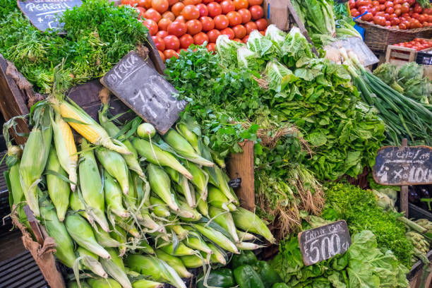istock Corncob, lettuce and tomatoes for sale at a market 841087318