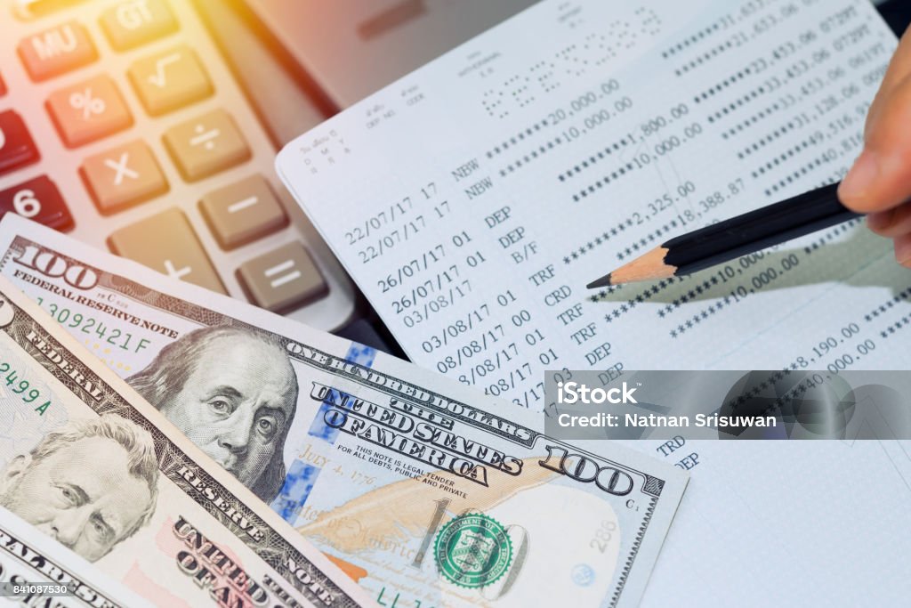 Account book bank. US dollar money,account book bank and calculator on table. Bank Account Stock Photo