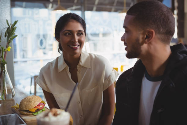 istock Young couple looking each other in cafe 841090686