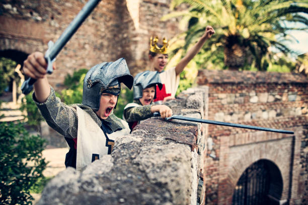 Knights defending the castle Little knights and the young queen cheering on the castle walls. Theay have defended the castle from the assault.
 fortified wall photos stock pictures, royalty-free photos & images
