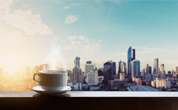 istock Morning hot coffee in sunrise, city backgrounds 841103690