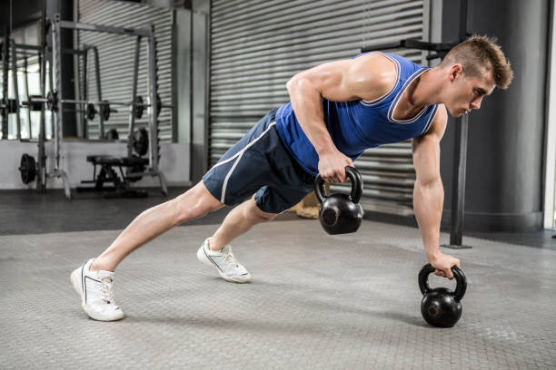 istock Muscular man doing push up with kettlebells 841106394