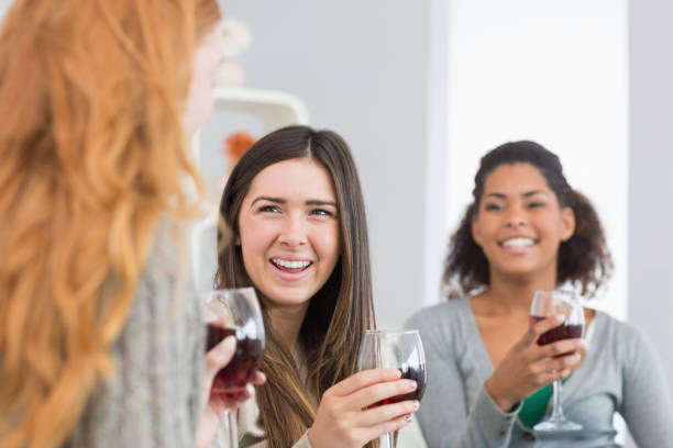 istock Cheerful friends with wine glasses enjoying a conversation at home 841110108
