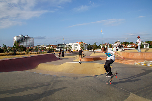 Melbourne, Australia: March 16, 2017: Young adults skateboard in a park on the foreshore at St Kilda. The park has been provided by the municipal council of Victoria.
