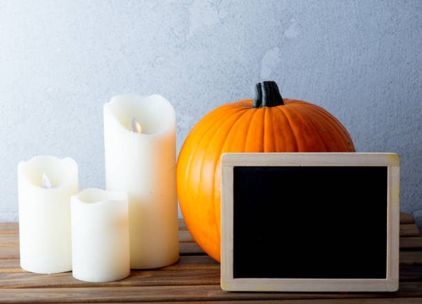 istock Fresh Autumn pumpkin and candles with menu blackboard 841110532