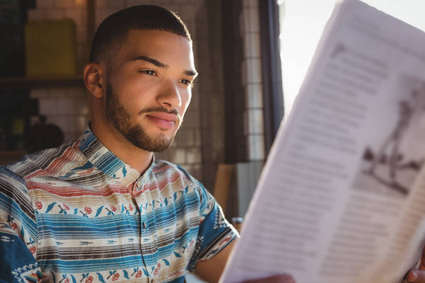 istock Man reading newspaper in cafe 841110738