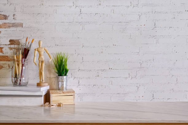 istock Mock up modern home decor with paintbrushs, dummy, houseplant. Artist workspace with copy space for products display montage. 841114146