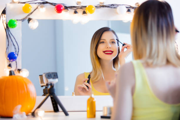 istock blogger woman applying cosmetics at camera 841114634