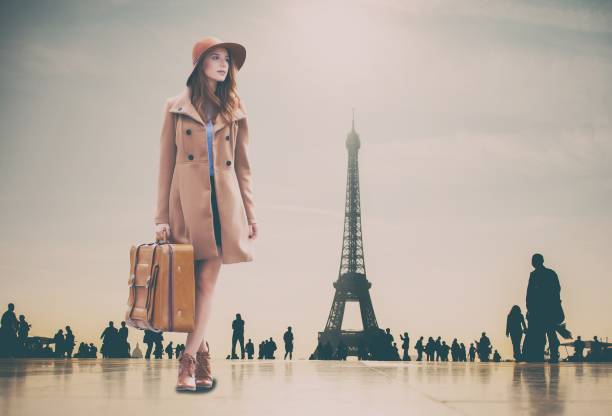 istock Redhead girl with suitcase and Eiffel tower 841117960
