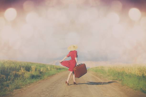 istock woman with suitcase on the road 841121128