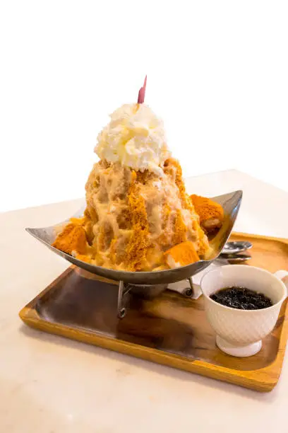 Photo of Thai tea shaved ice topped with whipped cream and white bread by tapioca pearl.