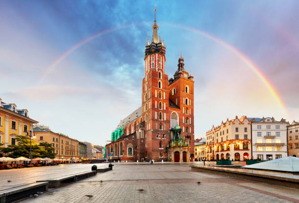 St. Mary's basilica in main square of Krakow with rainbow St. Mary's basilica in main square of Krakow with rainbow krakow stock pictures, royalty-free photos & images