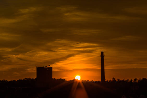 istock Dramatic cloudy orange sky with city silhouette 841128960