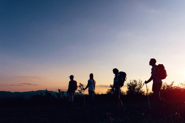 Walking in the sunglow hikers stock photo