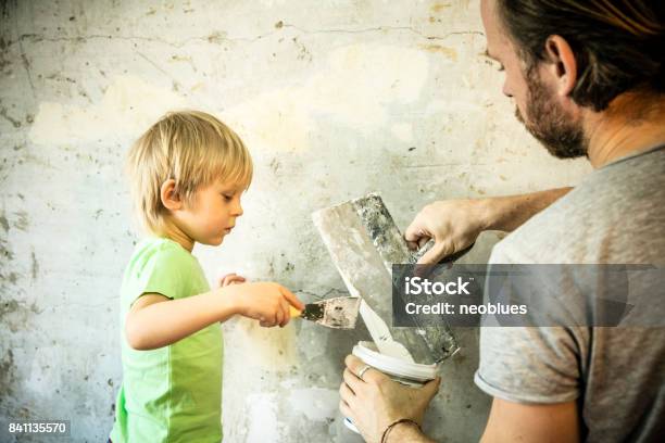 Father And Son With Trowel Plastering A Wall Stock Photo - Download Image Now - Father, Wall - Building Feature, Coating - Outer Layer