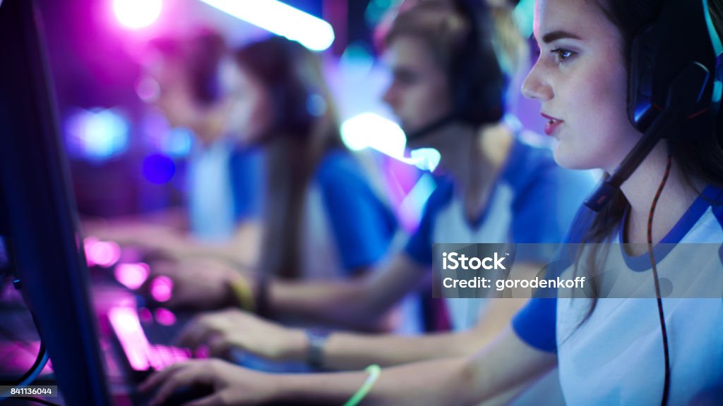 Team of Professional eSport Gamers Playing in Competitive Video Games on a Cyber Games Tournament. They using Microphones. Arts Culture and Entertainment Stock Photo