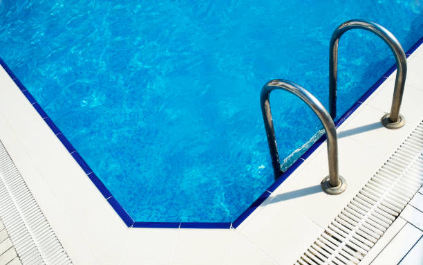 istock Grab bars ladder in the blue swimming pool 841140928