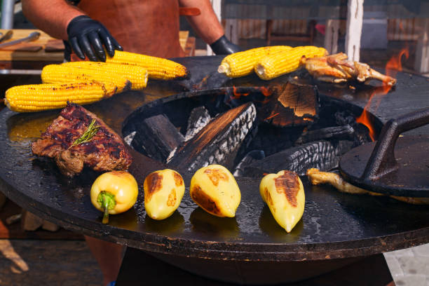 istock Man preparing barbecue outdoors. Cooking of grilled beef, chicken, corn and vegetables 841141070