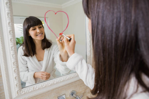 istock Young beautiful woman drawing big heart on mirror 841144146