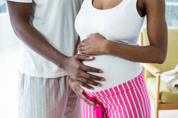 istock Pregnant couple embracing in bedroom 841146768