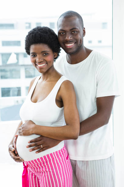 istock Pregnant couple embracing in bedroom 841146806