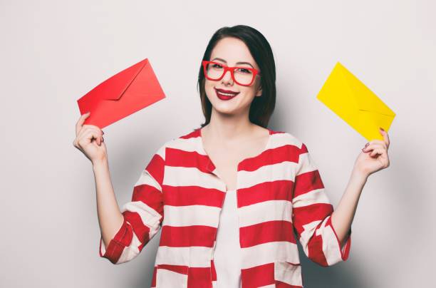 istock smiling woman with two envelopes 841147388