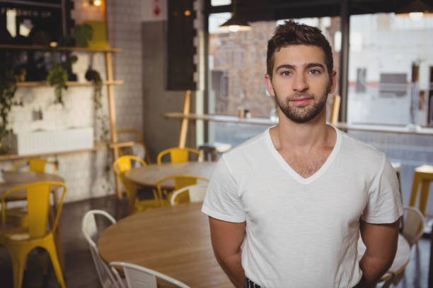 istock Portrait of confident waiter standing in cafe 841148120