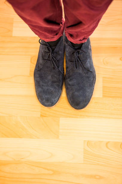 istock High angle of man wearing boots 841151596