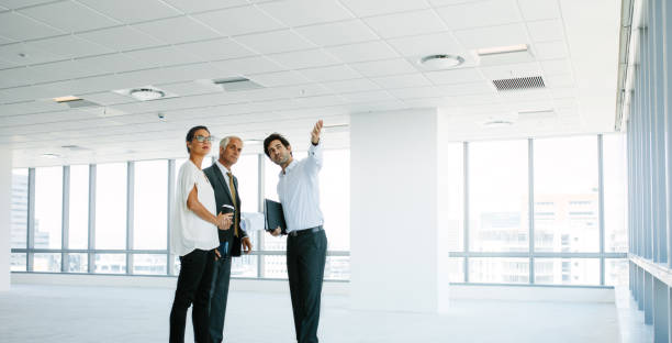 istock Real estate agent showing new office space to clients 841152086