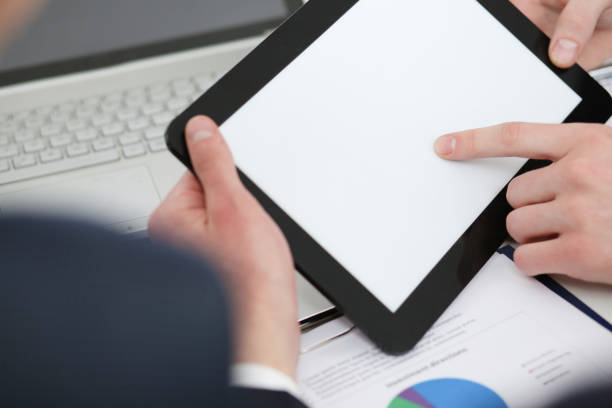 istock Businessmen reading financial review at tablet pc 841152700