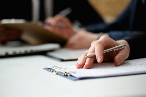 istock Hand of businessman signing document with pen 841152706