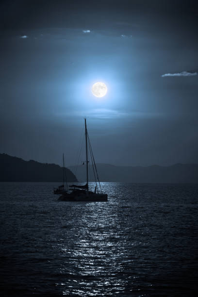 istock Sailing yacht illuminated by the light of a full moon 841158604