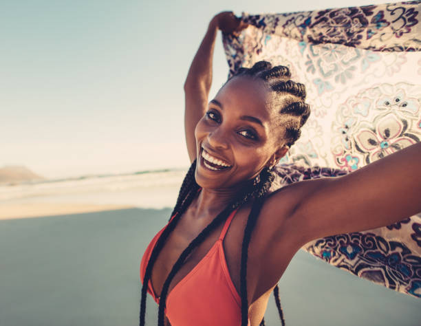 istock Young female with scarf on beach 841162034