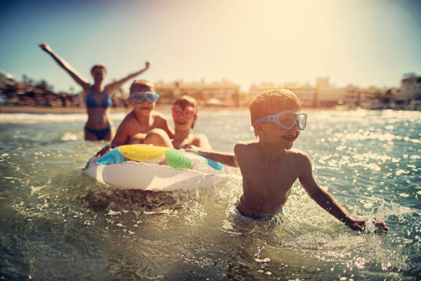 familia divirtiéndose en el mar de verano - family beach vacations travel fotografías e imágenes de stock