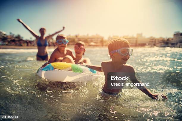 Family Having Fun In Summer Sea Stock Photo - Download Image Now - Family, Beach, Vacations