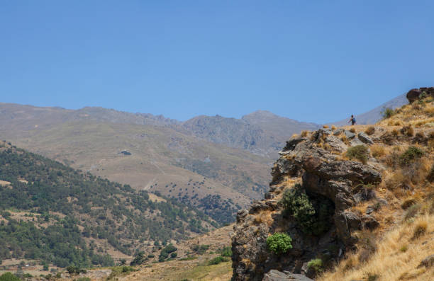 Hiker woman walking along Poqueira Gorge. Las Alpujarras Region, Granada, Spain
