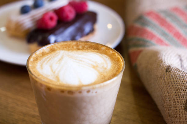 istock Cappuccino and cake with berries on table. Closeup. 841167674