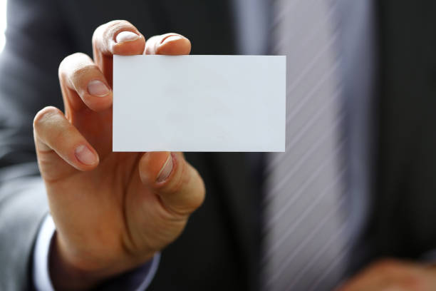 istock Male arm in suit give blank calling card to visitor 841167738