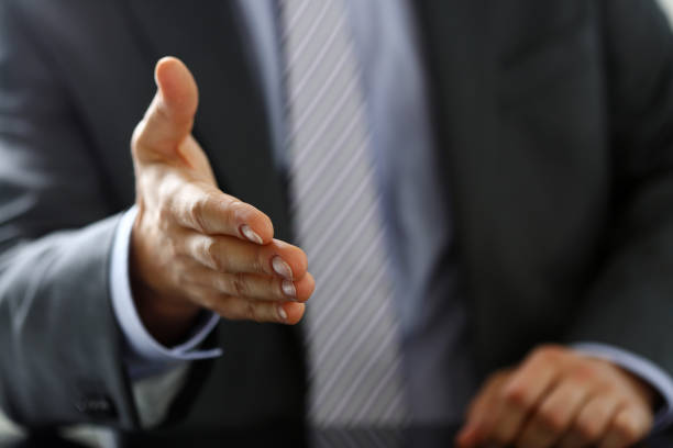 istock Man in suit and tie give hand as hello in office 841167768