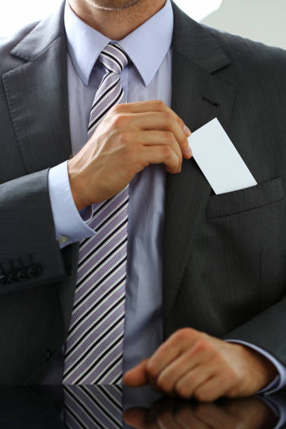istock Male arm in suit give blank calling card to visitor 841167774