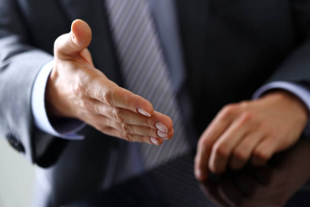 istock Man in suit and tie give hand as hello in office 841167784