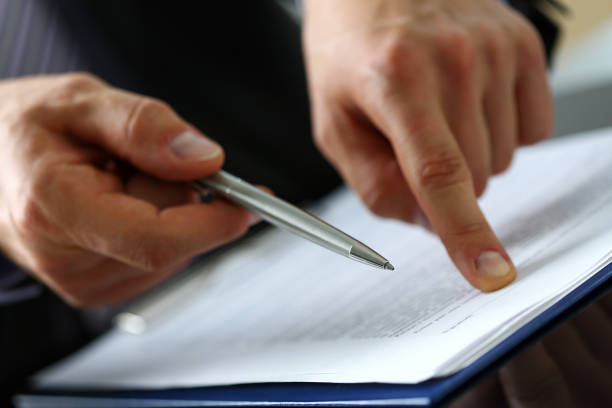 istock Male arm in suit offer contract form on clipboard pad 841167812