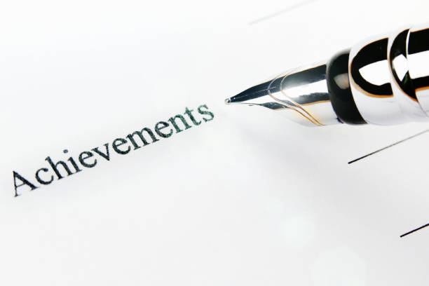 istock Pen filling out 'achievements' section on printed job application form 841176954