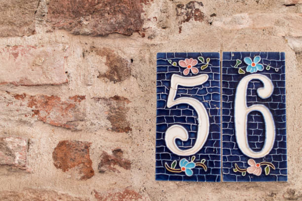 istock Number 56 on the brown brick wall 841180662