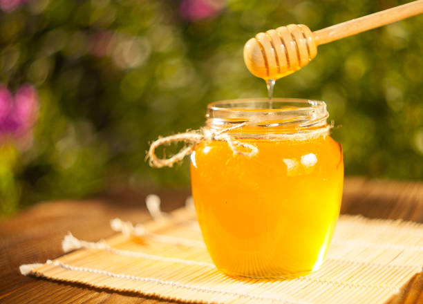 istock Delicious delicious honey in  jar on table 841180680