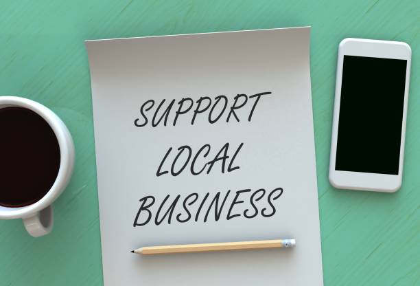 istock Support Local Business, message on paper, smart phone and coffee on table, 3D rendering 841184934