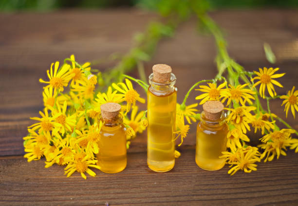 istock essential oil on table in beautiful bottle with flowers 841184958