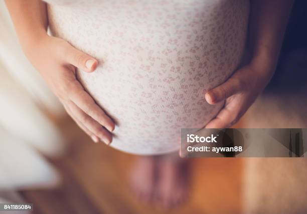 Pregnant Woman Touching Her Belly Stock Photo - Download Image Now - Pregnant, Women, Bumpy