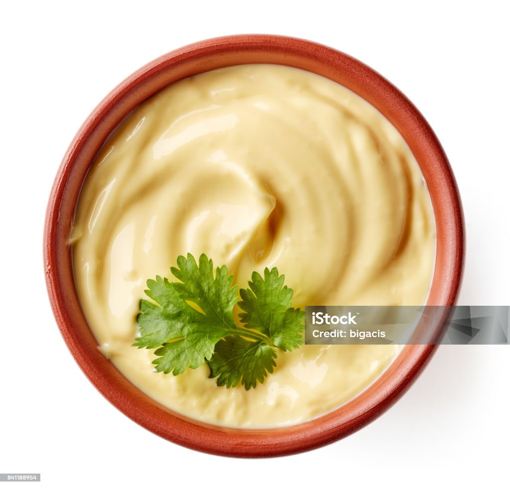 Bowl of mayonnaise isolated on white, from above Mayonnaise with parsley leaf in clay bowl isolated on white background, from above Above Stock Photo